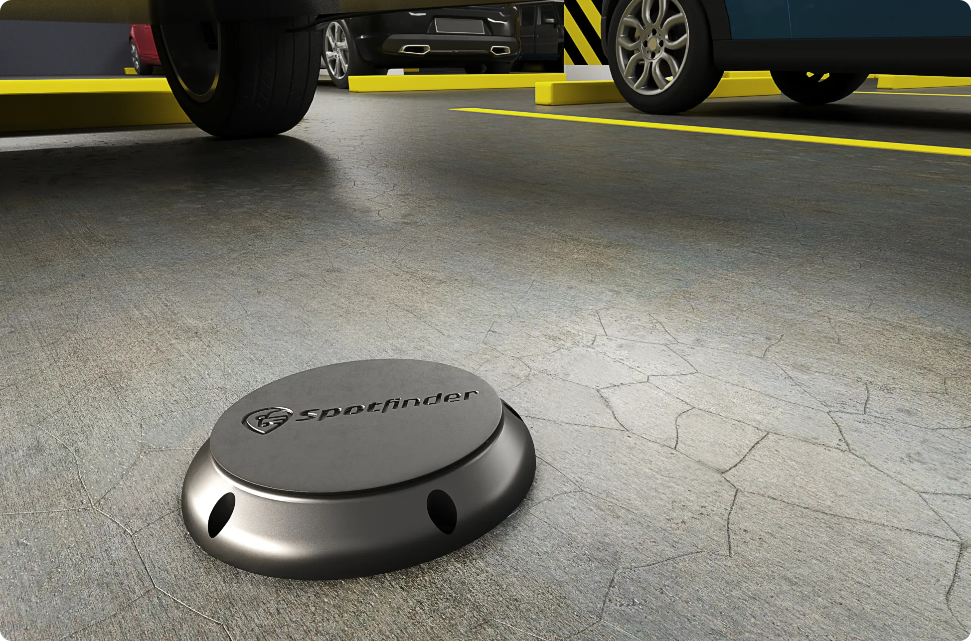 Original Spotfinder IoT hardware v1 held in hand — bulky grey plastic puck with engraved Spotfinder logo, the incumbent industrial design before the Comandos redesign broke it down to a small, wireless, economical unit