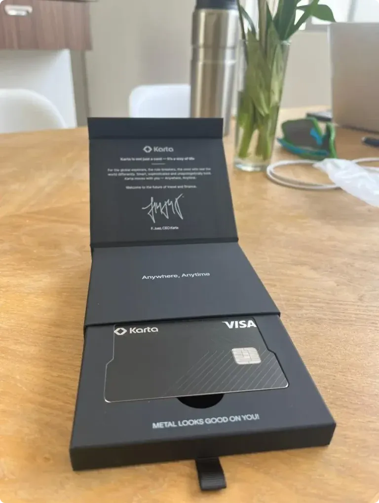 Karta welcome kit — metal card resting on its signed presentation box
