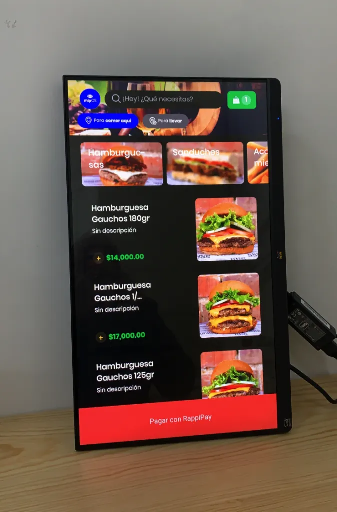 mipOS Kiosko redesigned resting screen for Chili's on a ROKU-native self-order device — colourful floating burgers, fries, hotdogs, tacos, coffee and a Special Offer 50% badge around the Chili's logo, tuned for any touch device regardless of restaurant size