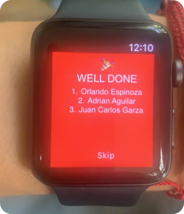 Stadio Apple Watch WELL DONE celebration — post-race podium on watchOS listing Orlando Espinoza, Adrian Aguilar and Juan Carlos Garza with a Skip action